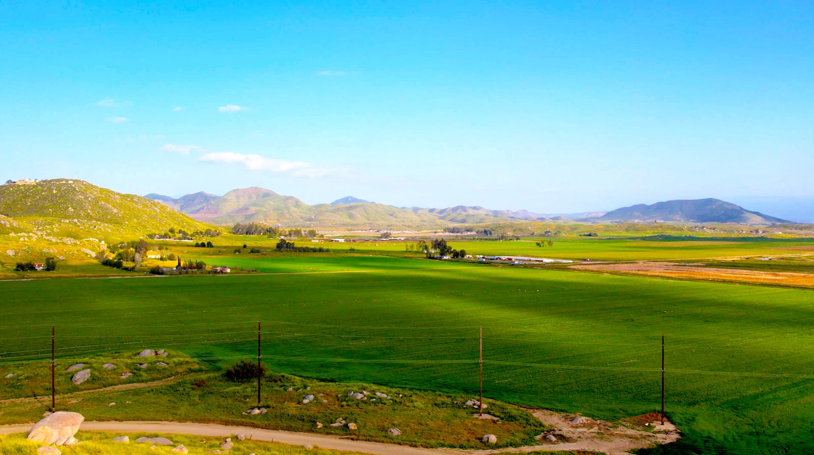 Aerial view of green fields and distant hills