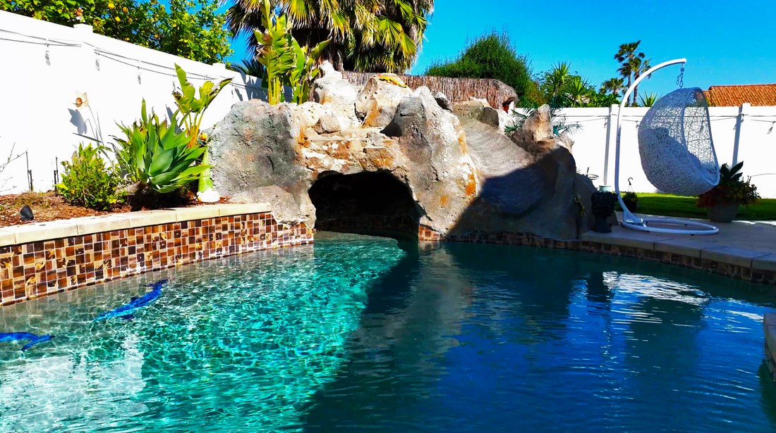 Aerial view of a pool and landscaped property