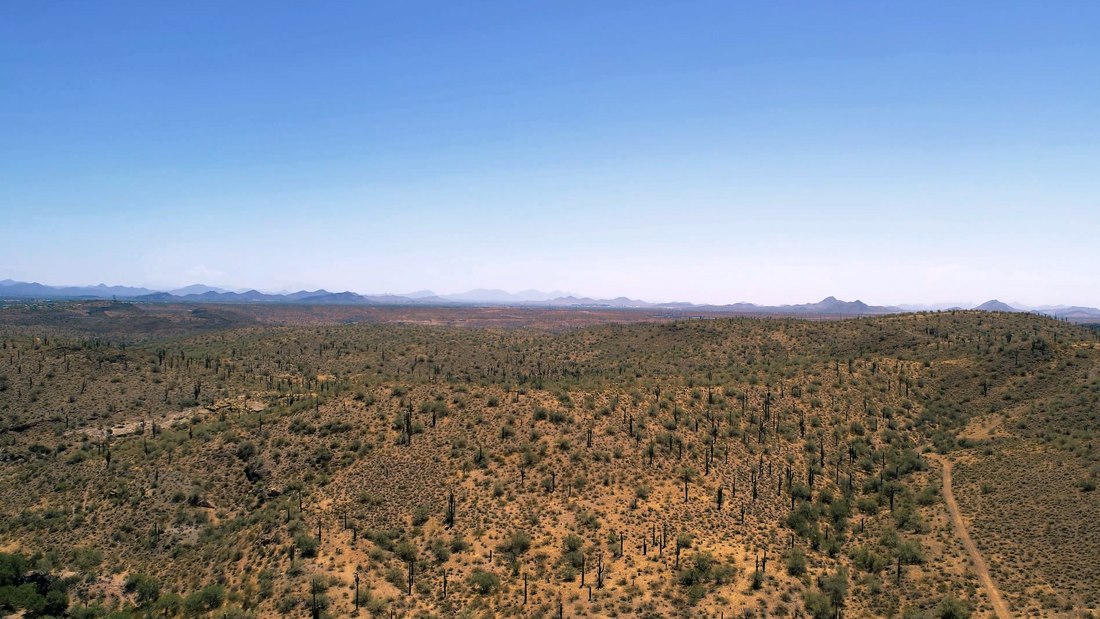 Aerial view across open foothill terrain
